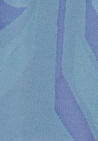 Textil med ett geometriskt mönster i olika nyanser av blått och lila. Har en slät yta och distinkta vävda designelement.