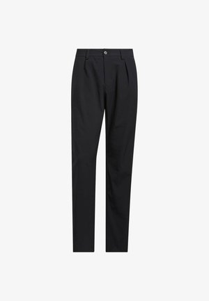 Mustat housut, jotka on valmistettu sileästä kankaasta. Niissä on vyötäröllä yksittäinen nappikiinnitys, edessä laskokset ja kapeat lahkeet.