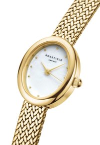 Montre à bracelet en maille dorée avec boîtier ovale, cadran en nacre blanche, index dorés et couronne. Nom de la marque "ROSEFIELD" affiché.