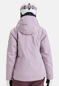 Light purple waterproof ski jacket with a hood, streamlined design, and elastic cuffs; worn with a white helmet and black neck warmer.