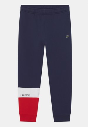 NUA - Tracksuit bottoms - navy blue/white/red
