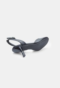 Black high-heeled sandal, made of smooth material, featuring a slender strap and a glossy heel, with a rounded toe and textured sole.
