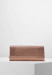 Kopertówka w różowym złocie z wyszukanym geometrycznym wzorem siateczki, gładką teksturą, prostokątnym kształtem i subtelnym detalem metalowym z boku.