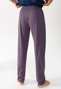 Pantaloni da pigiama a righe navy con linee verticali rosse e bianche, dotati di vita elastica e tessuto morbido, mostrati da dietro.
