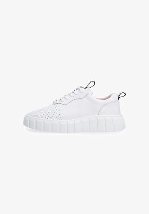 White low-top sneaker with perforated toe, thick ridged sole, lace-up closure, and black pull tabs on heel and tongue.