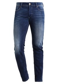 Mörkblå jeans i slim fit, med en urtvättad textur, femficksdesign och knapp- samt dragkedjestängning.