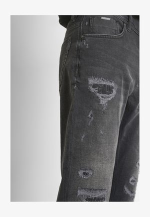 Zwarte denim jeans met versleten details, voorzien van uitgescheurde patches, een slim fit en een klassieke 5-pocket stijl. Contrasterende stiksels zichtbaar.