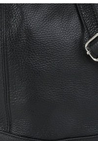 Black leather handbag with a textured surface, featuring a silver hardware buckle and a structured shape.