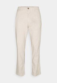 Beżowe lniane spodnie o prostej nogawce, z przodu zapinane na guzik, z bocznymi kieszeniami i gładką fakturą.
