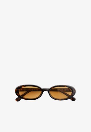 Lunettes de soleil ovales en écaille de tortue avec des verres teintés ambre et une monture fine, présentées sur un fond blanc.