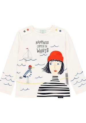 Long-sleeve white shirt with a red-beanie woman, a striped bird, a sailboat, blue waves, and text "Happiness comes in waves."