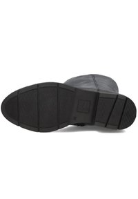 Black leather boot sole with a textured rubber surface. Features rectangular traction patterns and a branded section. Flat, angular shape.