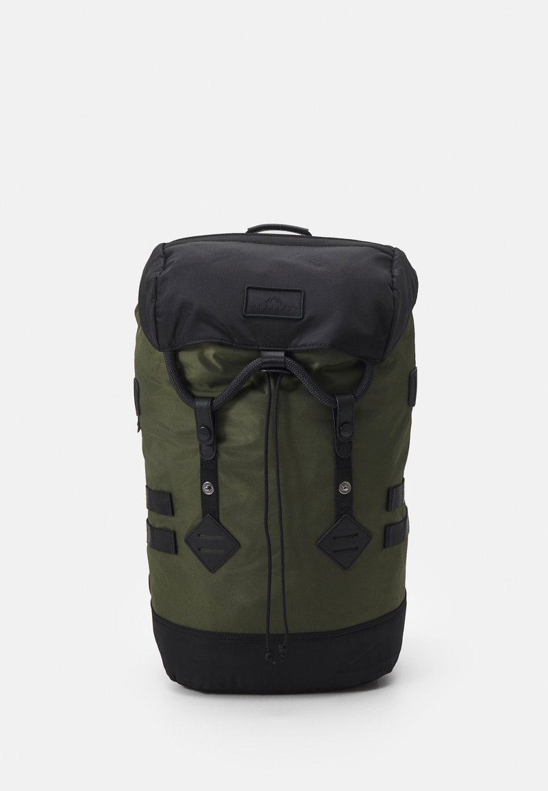 Green fabric backpack with a black top. Features leather accents, drawstring closure, and adjustable straps. Square bottom with exterior buckles.
