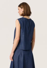 Denim sleeveless top with a rounded neckline, back zipper detail, and a relaxed fit, featuring a dark blue shade and subtle texture.