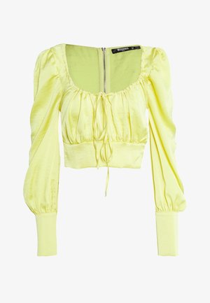 Lichtgele cropped blouse met lange pofmouwen, vierkante halslijn, detail met strik aan de voorkant en een ritssluiting aan de achterkant.