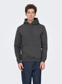 Gray fleece hoodie with a front kangaroo pocket, drawstring hood, ribbed cuffs, and hem. Paired with blue relaxed-fit jeans.