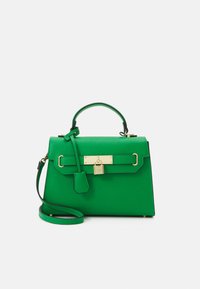 Green leather handbag with a structured design, gold hardware, a top handle, and a detachable shoulder strap. Features a lock accent and textured finish.