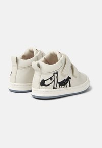 Scarpe alte bianche in pelle con cinturini in velcro, caratterizzate da un design grafico nero sul lato esterno e una suola in gomma blu.