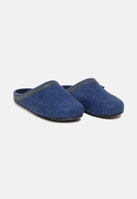 Navy blue felt slippers with a rounded toe, cushioned interior, and a contrasting dark trim around the opening. Flat, textured sole.