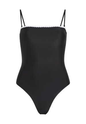 Costume da bagno intero nero con spalline sottili e bordo bianco a scallop lungo il decolletè, presentato su uno sfondo bianco.