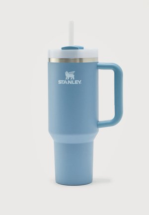 Vaso Stanley alto y azul claro con aislamiento, asa, tapa blanca y pajita transparente, mostrado sobre un fondo blanco liso.