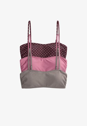 Trois camisoles courtes pour femmes empilées, une grise côtelée, une rose unie et une violet foncé à pois blancs, toutes avec des bretelles fines.