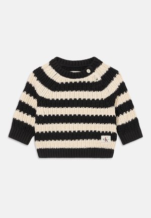 Black and beige striped knit sweater with three-quarter sleeves, round neckline, and two buttons at the shoulder. CK logo on the hem.