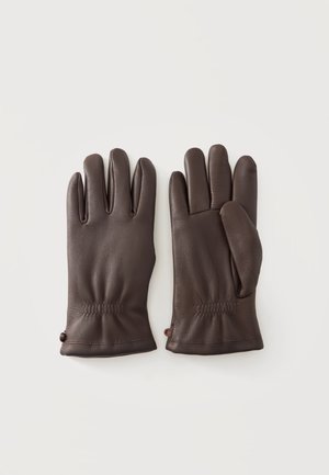 Paire de gants en cuir marron posés à plat avec des coutures visibles et de légers fronces aux poignets sur un fond clair.