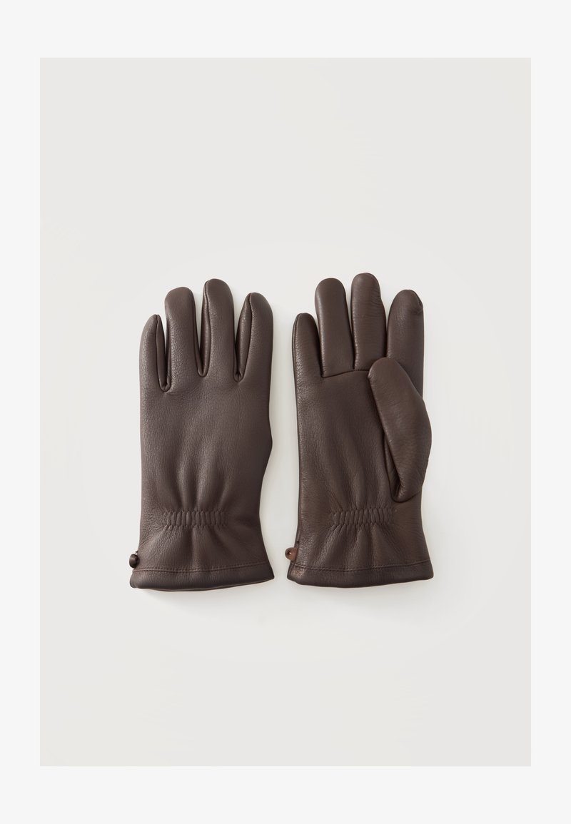 Paire de gants en cuir marron posés à plat avec des coutures visibles et de légers fronces aux poignets sur un fond clair.