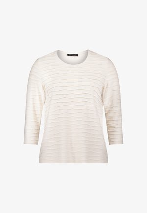 Teksturowana bluzka kremowa z rękawami o długości trzech czwartek, z falistym wzorem na przodzie i okrągłym dekoltem. Miękka tkanina, casualowy fason.
