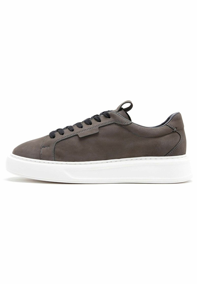 Sneaker in pelle grigia con punta rotonda, lacci neri, suola in gomma bianca spessa e dettagli di design minimalisti.