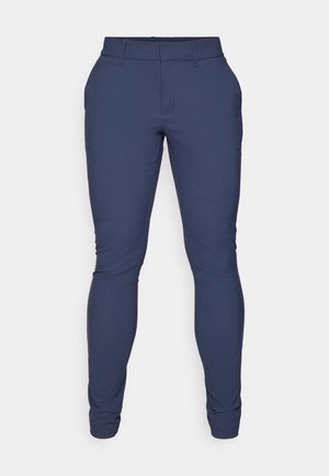Pantalon marine en tissu lisse et élastique. Présente une coupe slim, une taille plate et des ouvertures de jambes effilées. Pas d'ornements visibles.
