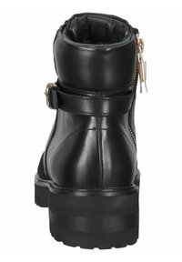 Bottine en cuir noir avec col rembourré, fermeture éclair latérale, sangle décorative avec boucle et semelle crantée épaisse, vue de dos.