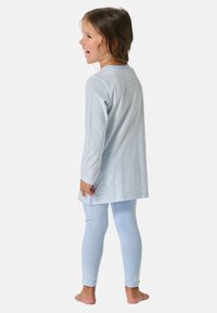 Light blue striped pajamas with a long-sleeve top and matching leggings, made from soft fabric, featuring a relaxed fit.
