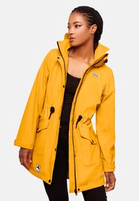 Yellow waterproof jacket with a hood, elastic drawstring waist, front pockets, and black zipper accents. Smooth texture, casual design.