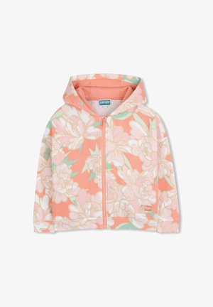 Veste à capuche zippée pour enfants en pêche avec un motif floral blanc et vert et tissu texturé, étiquette de la marque Kenzo sur l'ourlet.