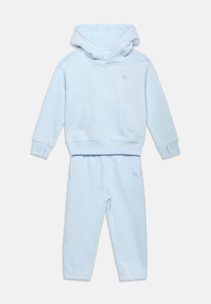 Light blue children's hoodie and matching sweatpants set with front pocket and small embroidered logo on chest and thigh.