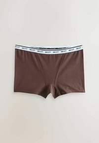 Boxers marron pour homme avec ceinture élastique blanche comportant le texte répété « NEXT », posés à plat sur un fond clair.