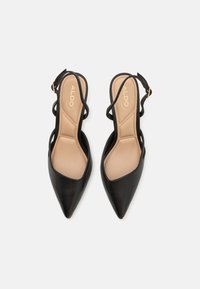 Black leather slingback heels with pointed toes, beige insoles, and thin straps. Features gold-tone hardware for adjustment. Flat sole.