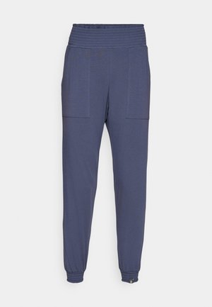 Navy blue jogger pants made of soft fabric, featuring a wide elastic waistband, two front pockets, and elastic cuffs at the ankles.