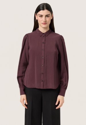 Burgundy button-up shirt with a collar, long puff sleeves, and a relaxed fit. Made from a smooth fabric with a subtle sheen.