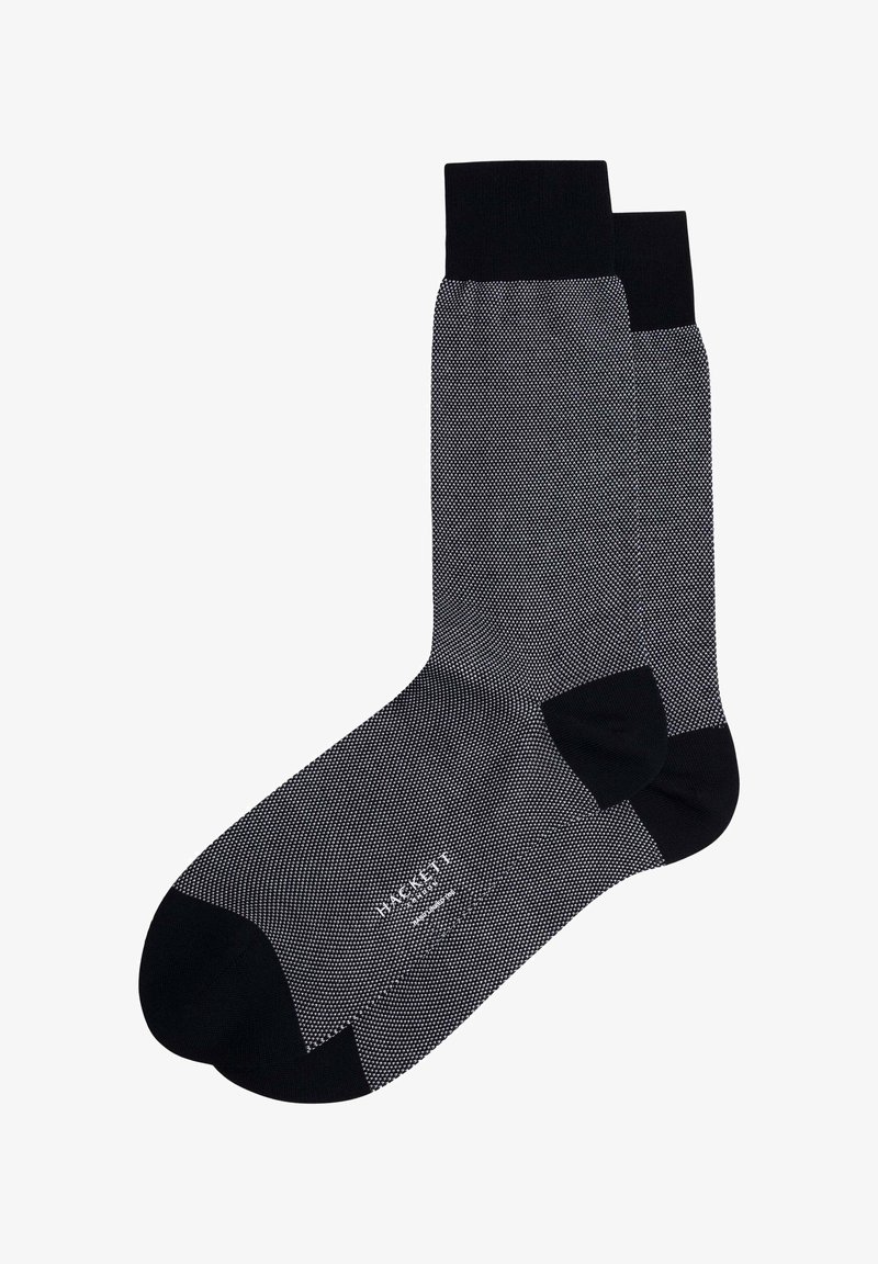 Chaussettes noires avec un motif à points gris texturé, des poignets côtelés et des zones renforcées au niveau des orteils et des talons pour plus de durabilité.
