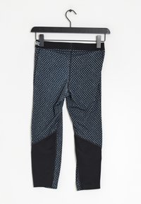 Leggingsit tummansinisestä kankaasta, jossa on valkoisia sydänkuvioita. Mustat yksityiskohdat sivuilla ja musta vyötärönauha. Sileä pinta.