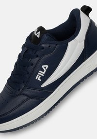 Marineblaue Ledersneaker mit weißen Akzenten und einer strukturierten Oberfläche. Dünne Schnürsenkel, perforierte Zehenpartie und Gummisohle mit Grip-Muster.