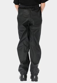 Zwarte waterdichte broek met een elastische tailleband, opgerolde enkels en een gladde, glanzende textuur. Eenvoudig ontwerp zonder zichtbare patronen.