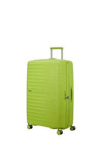 Valigia rigida verde brillante con righe verticali, maniglia retrattile e quattro ruote per la mobilità, dotata di chiusura a zip e maniglia laterale.