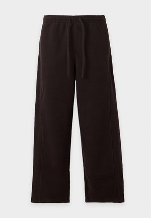 Pantaloni da ginnastica neri a vestibilità ampia con elastico in vita e coulisse, mostrati distesi su sfondo bianco.