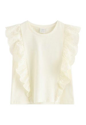 Flødefarvet ærmeløs top med bølget blondedetalje, der løber fra skuldrene til kanten på forsiden.