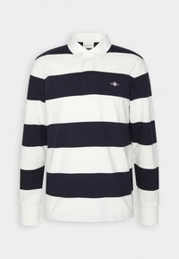 Maglietta da rugby a maniche lunghe con larghe righe orizzontali blu navy e bianche, colletto bianco e piccolo logo ricamato sul lato sinistro del petto.