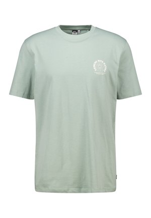 T-shirt in cotone verde chiaro con maniche corte, scollatura rotonda e stampa grafica bianca circolare nella zona sinistra del petto.